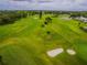 Aerial view of a beautifully maintained golf course with lush green fairways and sand traps at 2220 Spanish Dr # 4, Clearwater, FL 33763