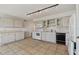 Practical kitchen space with white cabinetry and appliances, plus tile flooring at 2220 Spanish Dr # 4, Clearwater, FL 33763