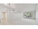 Spacious living room with neutral carpet, lots of natural light, and classic white trim at 2220 Spanish Dr # 4, Clearwater, FL 33763