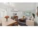 Open-concept living and dining area with modern furniture and large windows at 2220 Spanish Dr # 4, Clearwater, FL 33763