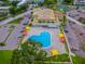 Aerial view of a community pool with lounge chairs and shade structures, surrounded by parking at 2220 Spanish Dr # 4, Clearwater, FL 33763