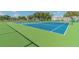 Community tennis courts featuring a lush green surround and a pristine blue court at 2220 Spanish Dr # 4, Clearwater, FL 33763