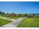 Lush green pathway to waterfront featuring a kayak dock and colorful array of kayaks at 2220 Spanish Dr # 4, Clearwater, FL 33763