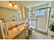 Clean bathroom features a shower with glass doors, a vanity with a sink, and ample lighting at 2351 Irish Ln # 43, Clearwater, FL 33763