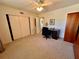 Comfortable bedroom includes neutral carpet, a ceiling fan, and a built-in closet for a cozy and organized space at 2351 Irish Ln # 43, Clearwater, FL 33763