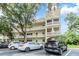 Apartment building featuring a distinctive turret design and well-maintained landscaping at 2351 Irish Ln # 43, Clearwater, FL 33763