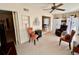 Inviting living room features neutral carpet, ceiling fan, and decorative chairs, creating a warm and cozy atmosphere at 2351 Irish Ln # 43, Clearwater, FL 33763