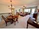 Cozy living and dining area features carpeted floors, neutral paint, and views from the covered porch at 2351 Irish Ln # 43, Clearwater, FL 33763