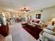 Open-concept living and dining area boasts carpeted floors and a ceiling fan at 2351 Irish Ln # 43, Clearwater, FL 33763