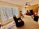 Cozy living room features wood paneling, a large window, and a comfortable recliner at 2351 Irish Ln # 43, Clearwater, FL 33763