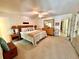 Spacious main bedroom features neutral carpet, a ceiling fan, and a stylish wooden dresser at 2351 Irish Ln # 43, Clearwater, FL 33763