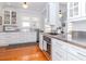 Chef's kitchen featuring stainless steel countertops and view into bright dining area at 2513 W Morrison Ave, Tampa, FL 33629