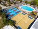 Aerial view of community pool, basketball and tennis courts, and a park area, highlighting recreational amenities at 3002 N 16Th St, Tampa, FL 33605