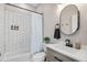 Modern bathroom with subway-tiled shower, sleek vanity, oval mirror, and a minimalist design at 3002 N 16Th St, Tampa, FL 33605