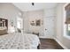 Bedroom featuring hardwood floors and neutral paint with an adjacent sitting area at 3002 N 16Th St, Tampa, FL 33605