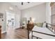 Cozy bedroom featuring wood floors, neutral walls, and an adjacent kitchen view for added convenience at 3002 N 16Th St, Tampa, FL 33605