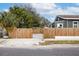 Charming home exterior featuring a wooden fence and gate, enhancing curb appeal and privacy at 3002 N 16Th St, Tampa, FL 33605