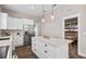 Kitchen island featuring a white countertop and adjacent stainless steel appliances with the primary bedroom in view at 3002 N 16Th St, Tampa, FL 33605