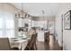 Open kitchen and dining area featuring stainless steel appliances, a center island, and modern finishes at 3002 N 16Th St, Tampa, FL 33605