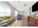 Bright living room featuring hardwood floors, a large window, and open access to the kitchen at 3002 N 16Th St, Tampa, FL 33605