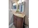 This bathroom has a granite countertop and a warm-toned vanity cabinet at 3403 Garfield Dr, Holiday, FL 34691