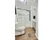 This bathroom includes a toilet, shower and gray vanity at 34344 Timberland Blvd, Wesley Chapel, FL 33543