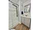 Bathroom featuring modern fixtures, a sleek shower, and gray vanity at 34344 Timberland Blvd, Wesley Chapel, FL 33543
