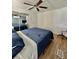 This is a cozy bedroom with a ceiling fan and wood laminate floors at 34344 Timberland Blvd, Wesley Chapel, FL 33543