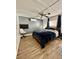 Bedroom area featuring wood laminate floors and modern ceiling fan at 34344 Timberland Blvd, Wesley Chapel, FL 33543