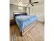 This is a bedroom with wood laminate flooring and a ceiling fan at 34344 Timberland Blvd, Wesley Chapel, FL 33543