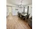 The dining room features wood floors and a modern chandelier at 34344 Timberland Blvd, Wesley Chapel, FL 33543