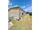 The exterior of the home is a bright beige that complements the surrounding green lawn at 34344 Timberland Blvd, Wesley Chapel, FL 33543