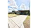 Wide angle view of a single-story home with a well-maintained lawn and covered parking at 34344 Timberland Blvd, Wesley Chapel, FL 33543