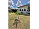 Modest single story home featuring a young tree planted in the front yard at 34344 Timberland Blvd, Wesley Chapel, FL 33543