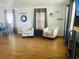 Cozy living room featuring two armchairs, wood-look flooring, and ample natural light at 34344 Timberland Blvd, Wesley Chapel, FL 33543