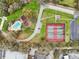 Aerial view of community pool, park, and tennis courts at 3782 Lake St George Dr, Palm Harbor, FL 34684