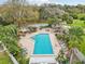 Community pool area with lounge seating and lush landscaping at 3782 Lake St George Dr, Palm Harbor, FL 34684