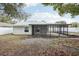 Exterior backyard view of home, patio, and fence at 3782 Lake St George Dr, Palm Harbor, FL 34684