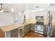 Kitchen with stainless steel appliances and granite countertops open to dining room at 3782 Lake St George Dr, Palm Harbor, FL 34684