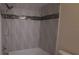Tiled shower and tub with decorative accents at 3859 Pheasant Ct, Palm Harbor, FL 34685