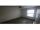 Bedroom features neutral carpet and a bright window with natural light at 3859 Pheasant Ct, Palm Harbor, FL 34685
