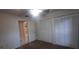 Bedroom with ceiling fan, closet, and access to ensuite bath at 3859 Pheasant Ct, Palm Harbor, FL 34685