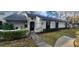 Charming single-story home with manicured front yard and welcoming entryway gate at 3859 Pheasant Ct, Palm Harbor, FL 34685