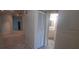 Hallway leads to a well-lit bathroom with white vanity and decorative mirror at 3859 Pheasant Ct, Palm Harbor, FL 34685