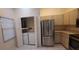 Kitchen featuring stainless steel refrigerator and included washer and dryer at 3859 Pheasant Ct, Palm Harbor, FL 34685