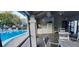 View of the pool with covered patio and exterior kitchen at 3859 Pheasant Ct, Palm Harbor, FL 34685