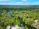 Stunning aerial view of a riverfront property surrounded by lush greenery and a private boat dock at 3908 Alafia Blvd, Brandon, FL 33511