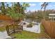 Backyard steps lead to a patio with firepit overlooking a serene river, surrounded by mature trees and a fence at 3908 Alafia Blvd, Brandon, FL 33511