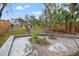 Spacious backyard with a fire pit, stairs, partial patio, and scenic river view, enclosed by a wooden fence at 3908 Alafia Blvd, Brandon, FL 33511