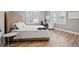 Bright bedroom featuring light wood floors, natural light, a desk, and a queen bed at 3908 Alafia Blvd, Brandon, FL 33511